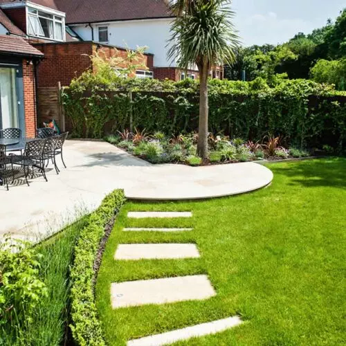 A Rich garden with a patio and steps.